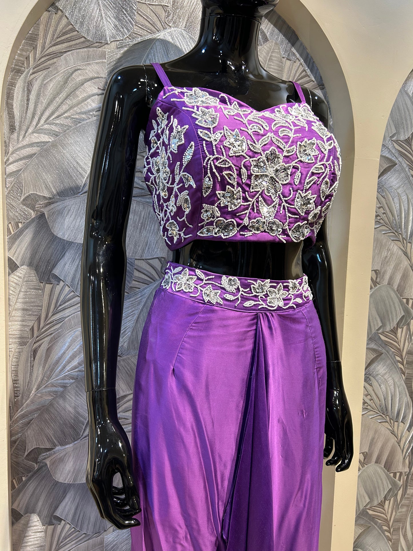 Purple silk crop top with white floral embroidery, paired with a draped silk skirt for party and festive wear