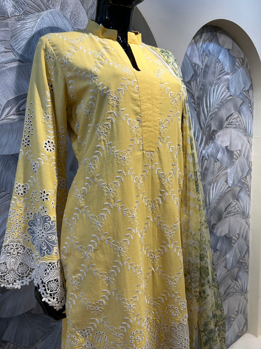 Vibrant orange-yellow cotton suit with white thread embroidery and heavy eyelet cutwork at hem and sleeves