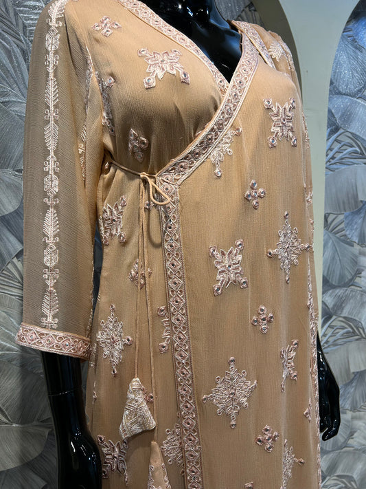 Peach chiffon wrap-style suit with thread embroidery, tassel tie detail, and matching embroidered dupatta