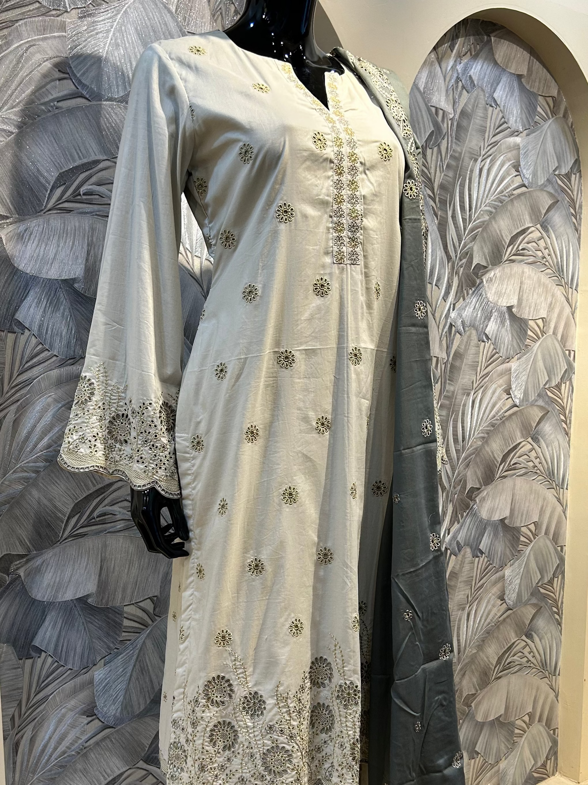 White coffee cotton suit with white thread embroidery, floral eyelet cutwork on hem and sleeves, paired with grey embroidered dupatta