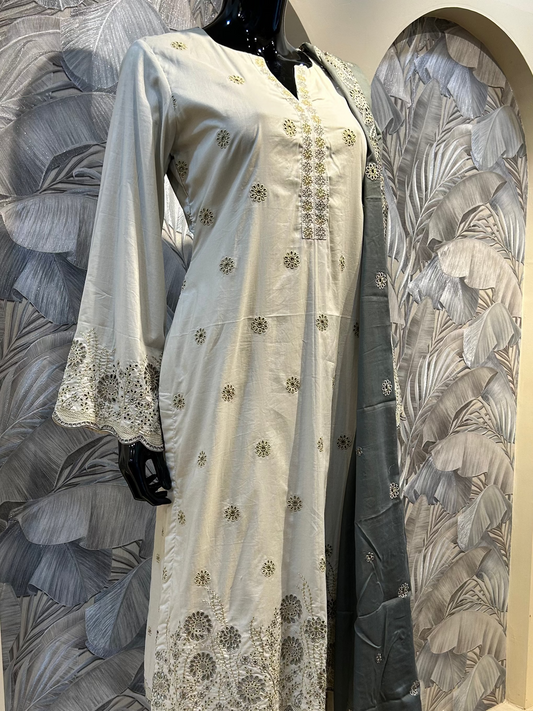 White coffee cotton suit with white thread embroidery, floral eyelet cutwork on hem and sleeves, paired with grey embroidered dupatta