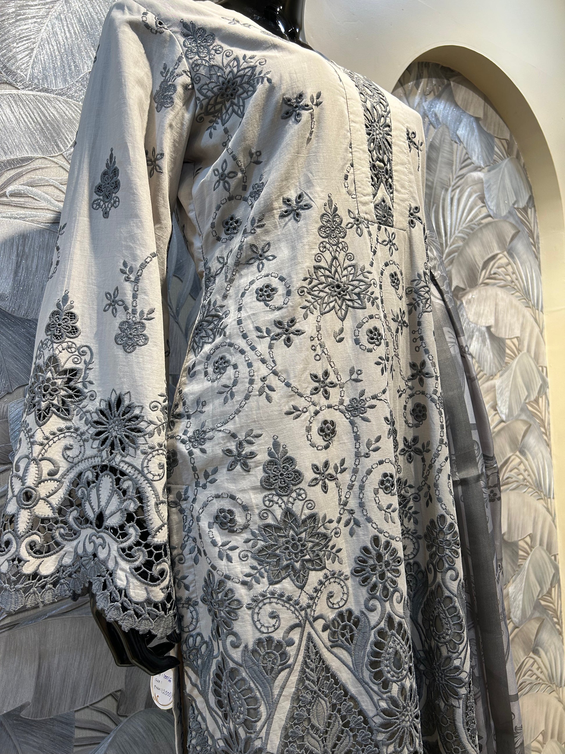 Pastel gray cotton suit with intricate black thread embroidery, floral cutwork on hem and sleeves, paired with gray printed dupatta