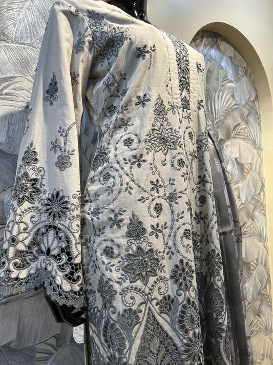Pastel gray cotton suit with intricate black thread embroidery, floral cutwork on hem and sleeves, paired with gray printed dupatta